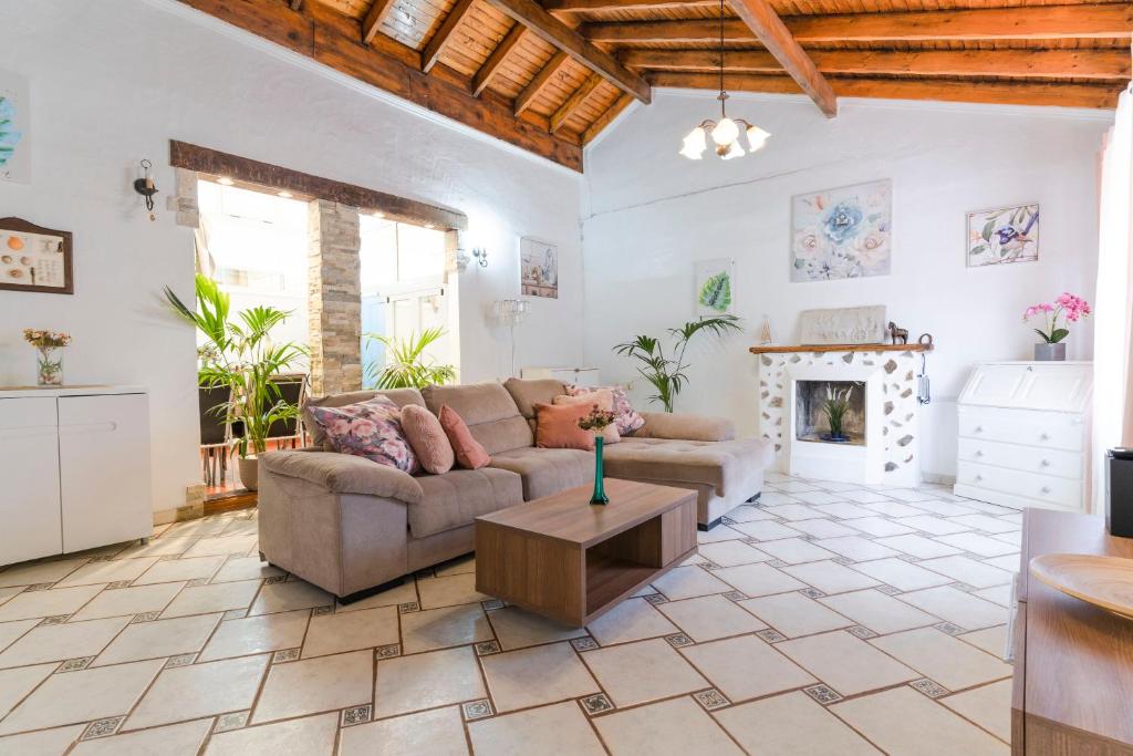a living room with a couch and a fireplace at Villa Neon Tenerife in Arona