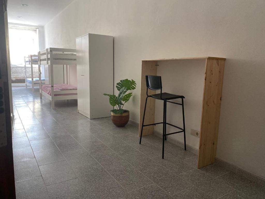 a room with a chair and a table and a stool at Casa Augusta 3 in Braga
