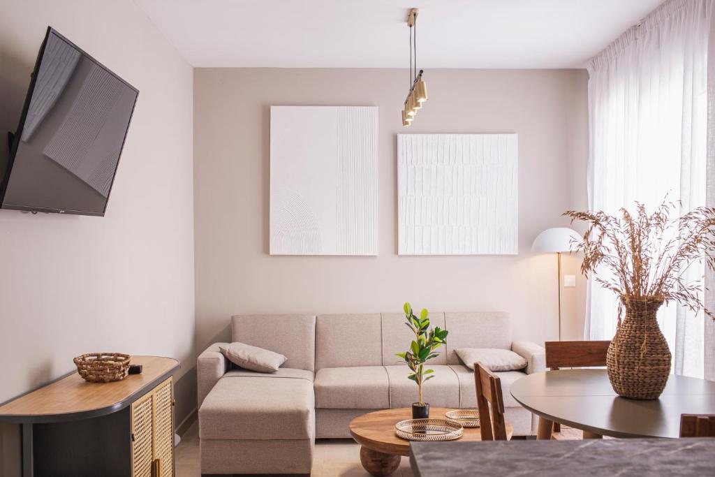 a living room with a couch and a table at Apartamentos Martalia Áticos Deluxe in Ronda