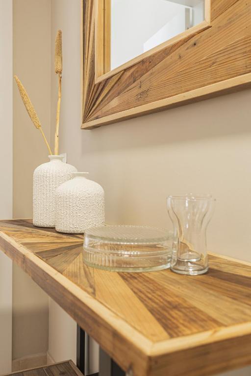 a wooden counter with two vases on top of it at Apartamentos Martalia Áticos Deluxe in Ronda
