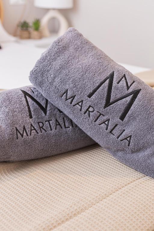 a pair of towels sitting on top of a bed at Apartamentos Martalia Áticos Deluxe in Ronda