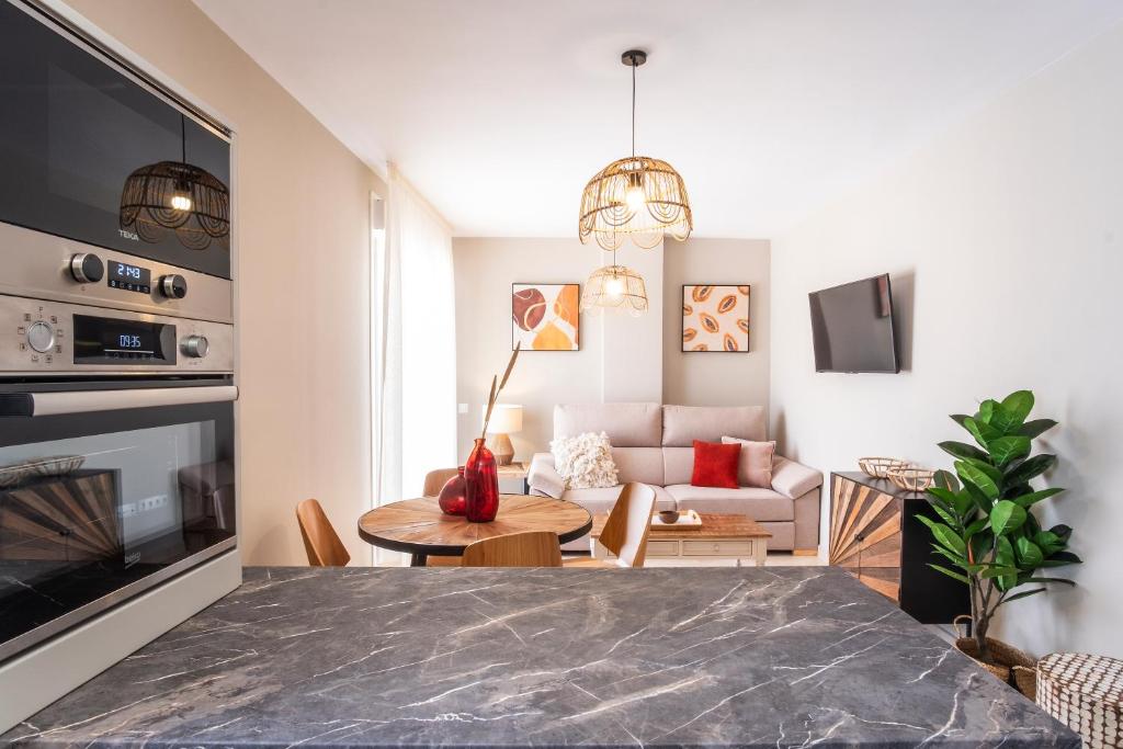 a living room with a table and a couch at Apartamentos Martalia Áticos Deluxe in Ronda