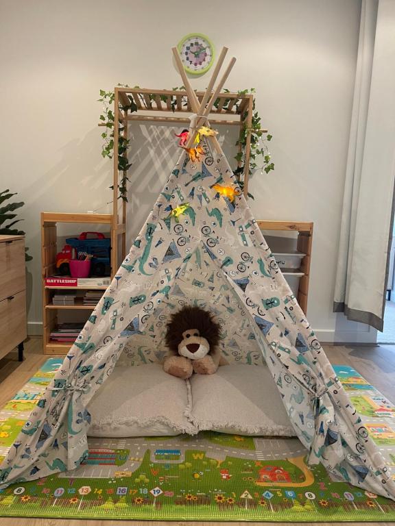 a teddy bear in a teepee bed in a room at Glenelg resort style beachside apartment in Glenelg