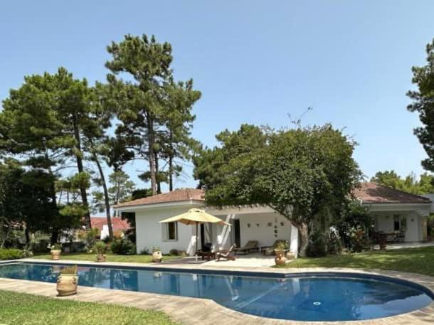 a house with a swimming pool in front of a house at Villa avec piscine privée in Tabarka