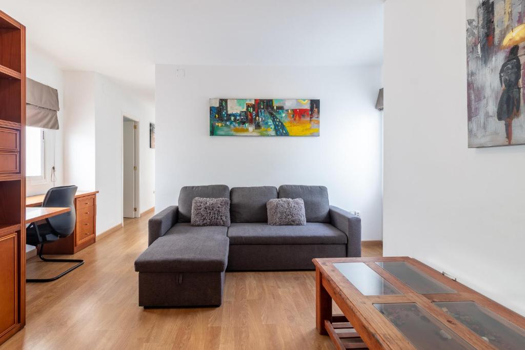 a living room with a couch and a table at Flatguest Triana urbano in Las Palmas de Gran Canaria