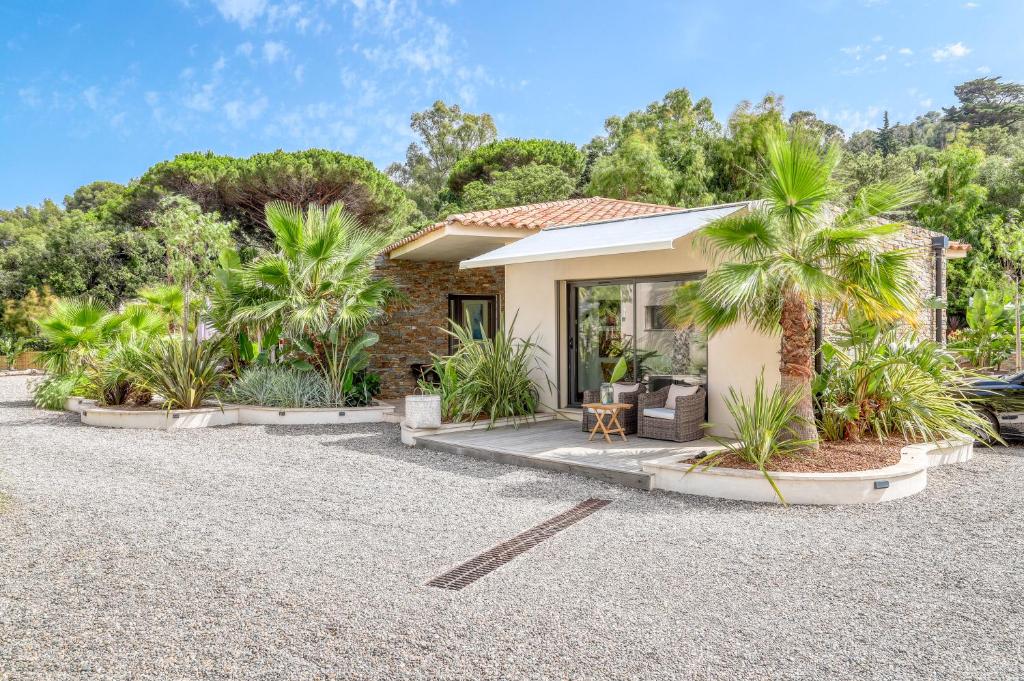 a house with palm trees in front of it at Akwabay - Les Villas du Cap in Le Lavandou