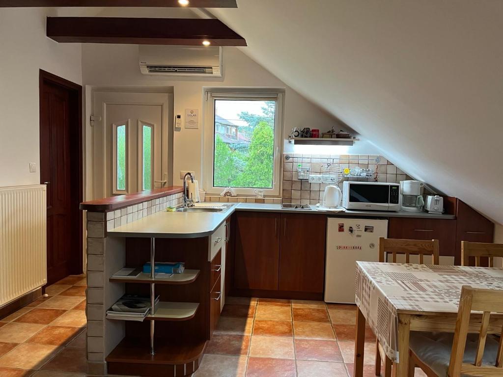 a kitchen with a sink and a counter top at Solar Apartman in Vonyarcvashegy