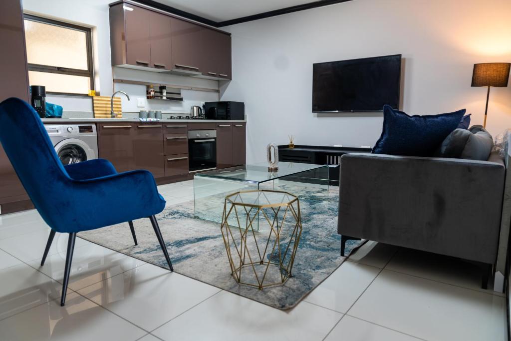 a living room with a couch and a glass table at Fully furnished apartment. in Sandton