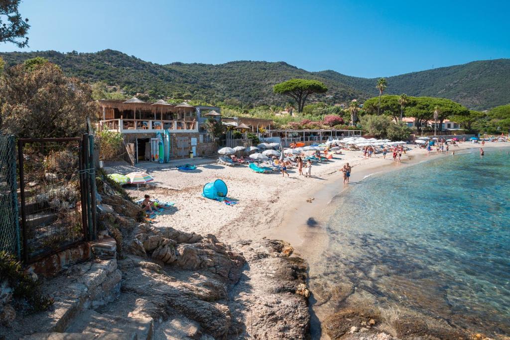 a group of people on a beach near the water at Akwabay - Les Villas du Cap in Le Lavandou