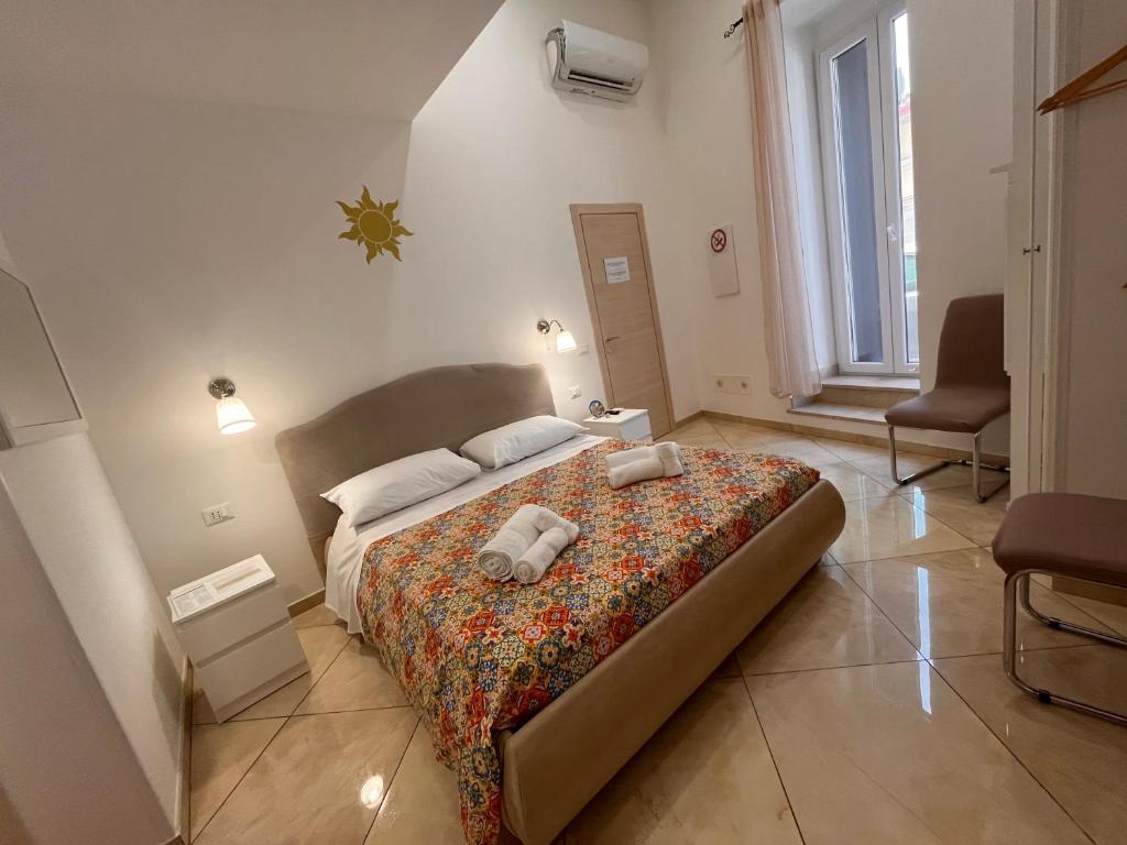 Postel nebo postele na pokoji v ubytování Esse House's Noto