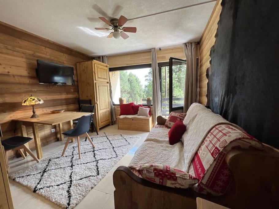 a bedroom with a bed and a table and a desk at Les Camparoles in Font Romeu Odeillo Via