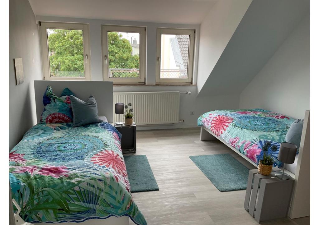 1 dormitorio con 2 camas y 2 ventanas en Seeadler, en Bremerhaven