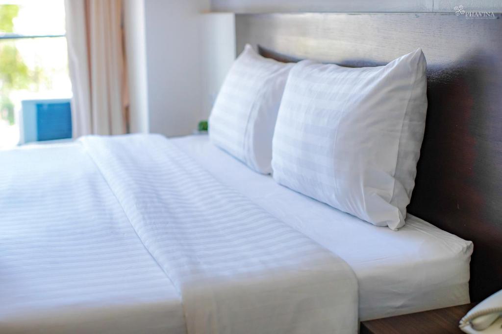Postel nebo postele na pokoji v ubytování Phavina Hotel Rayong SHA Extra Plus