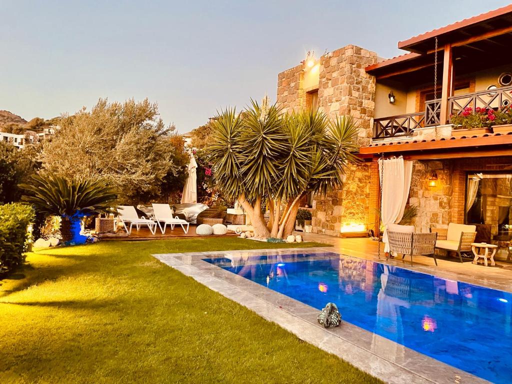 a house with a swimming pool in the yard at Great view stone house private pool! in Bodrum City
