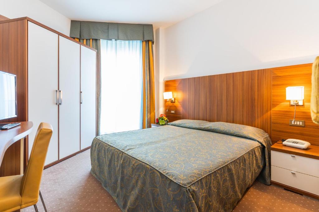 Postel nebo postele na pokoji v ubytování Hotel Touring