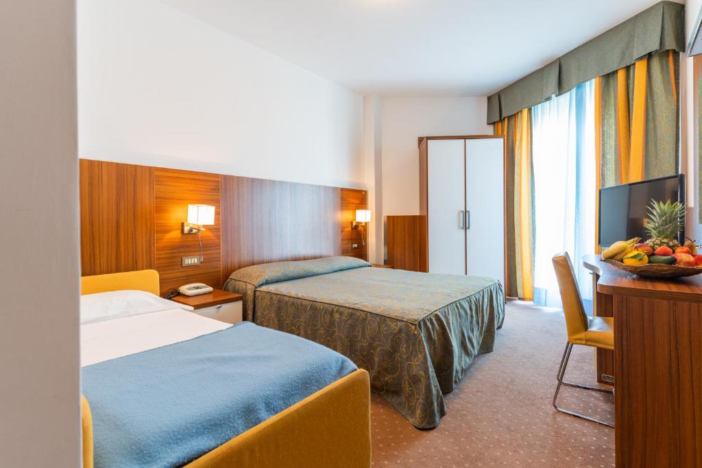 Postel nebo postele na pokoji v ubytování Hotel Touring