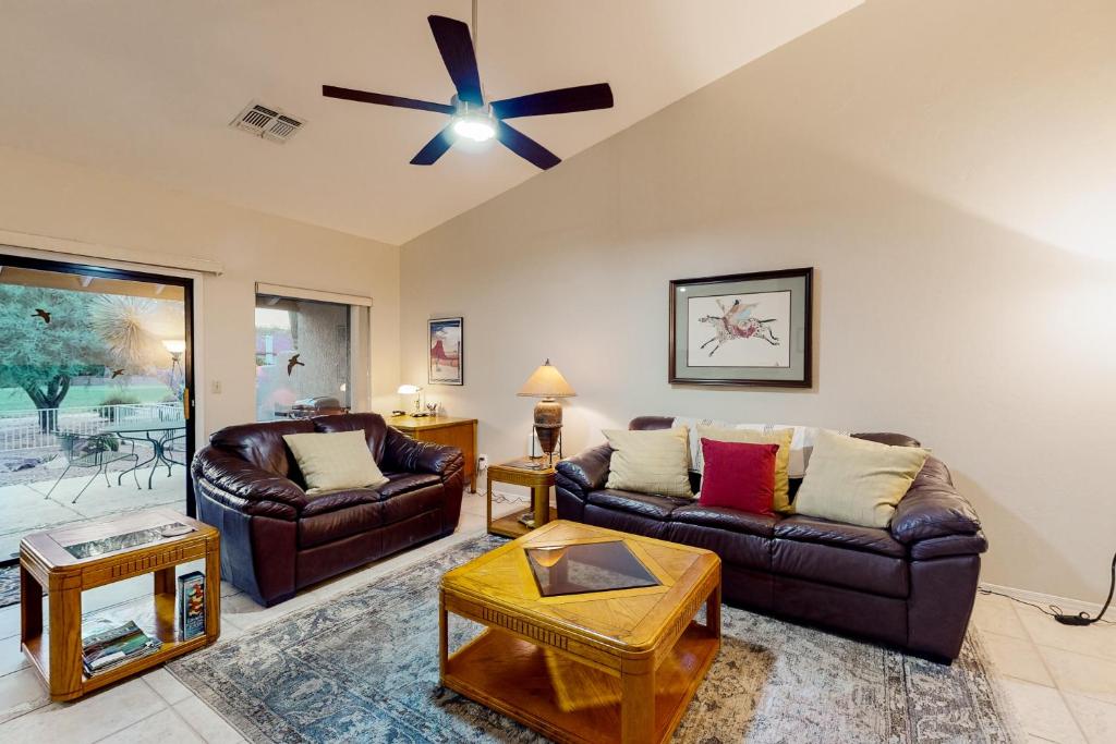 a living room with two couches and a ceiling fan at Tucson National #8689 in Tucson