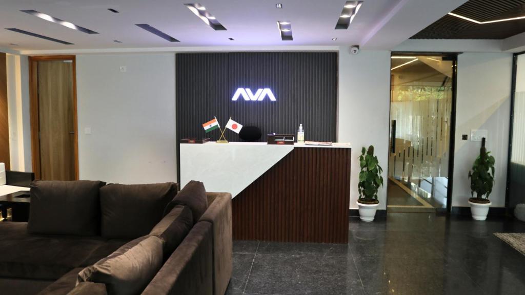 an office lobby with a reception desk with a m sign at AVA Hotels and Corporate Suites in Gurgaon