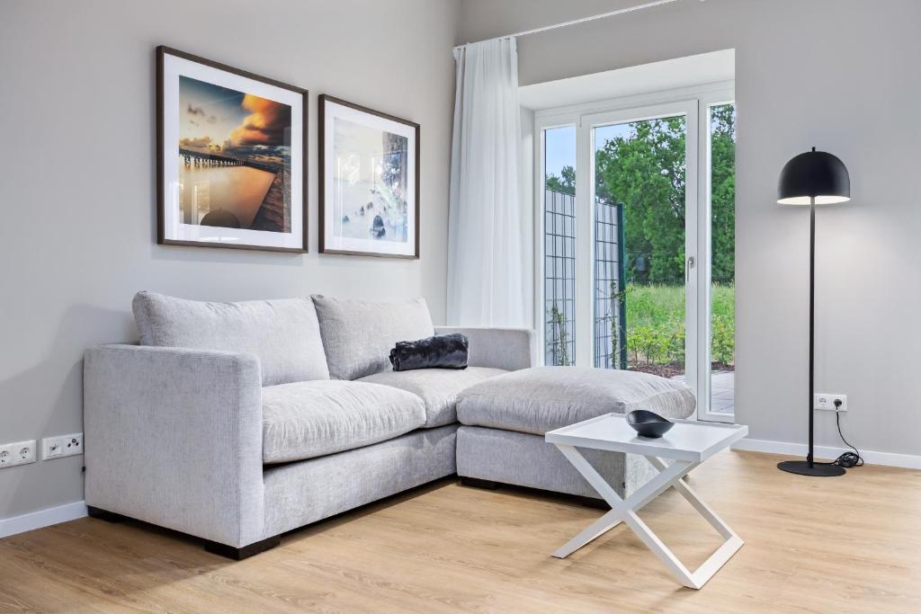 a living room with a couch and a table at Strandresidenzen Binz-Prora Strandresidenzen Binz-Prora V0 2 in Binz