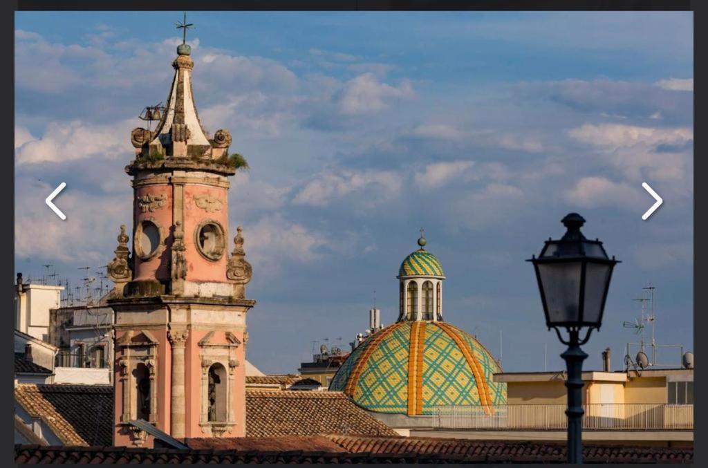 a clock tower on top of a building with a street light at Casa Maria Al Verdi in Salerno