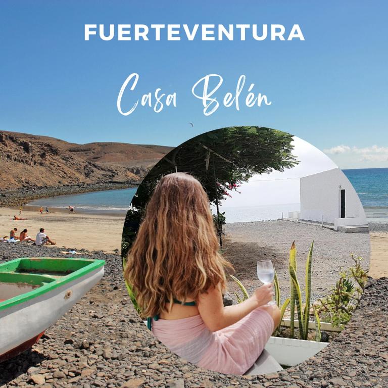 a little girl sitting in a boat on the beach at Casa Belén in Pozo Negro