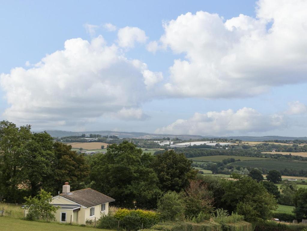 a house on a hill with a view of the countryside at Palace Bungalow in Hereford