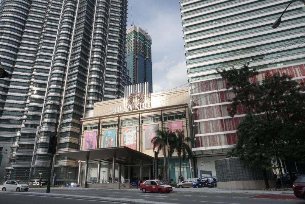 un gran edificio con un coche aparcado delante de él en Park View KLCC ,by DeLive Home en Kuala Lumpur