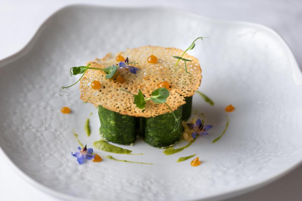 a white plate with a piece of food on it at Savoy Beach Hotel & Thermal Spa in Bibione