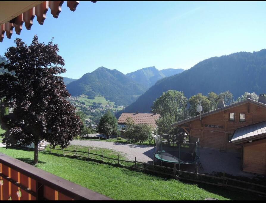a view of the mountains from a balcony of a house at Studio au pied des pistes in Châtel