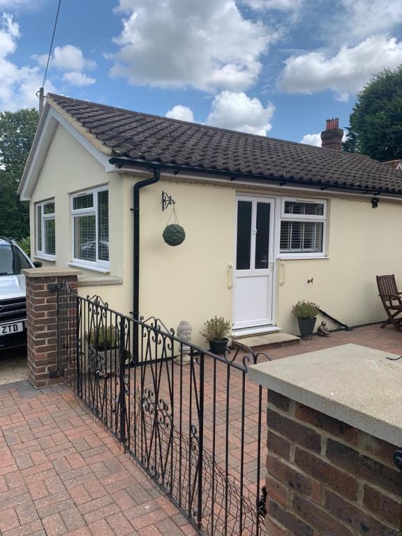 a white house with a black fence at Angies Place in Midhurst