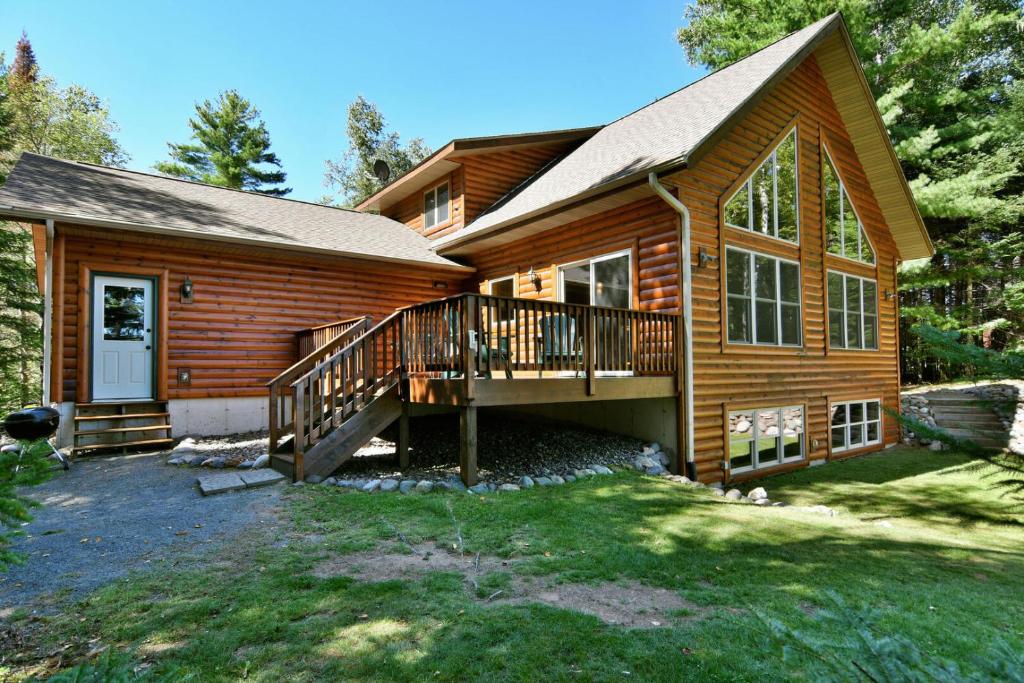 a log home with a large porch and a deck at Lost Dutchman in Hayward