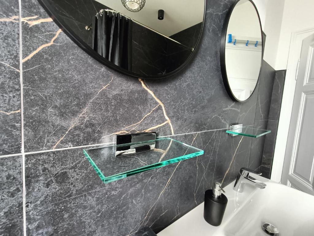 a bathroom with a mirror and a sink at Ferienwohnung Coburg, familienfreundlich und stilvoll in Coburg