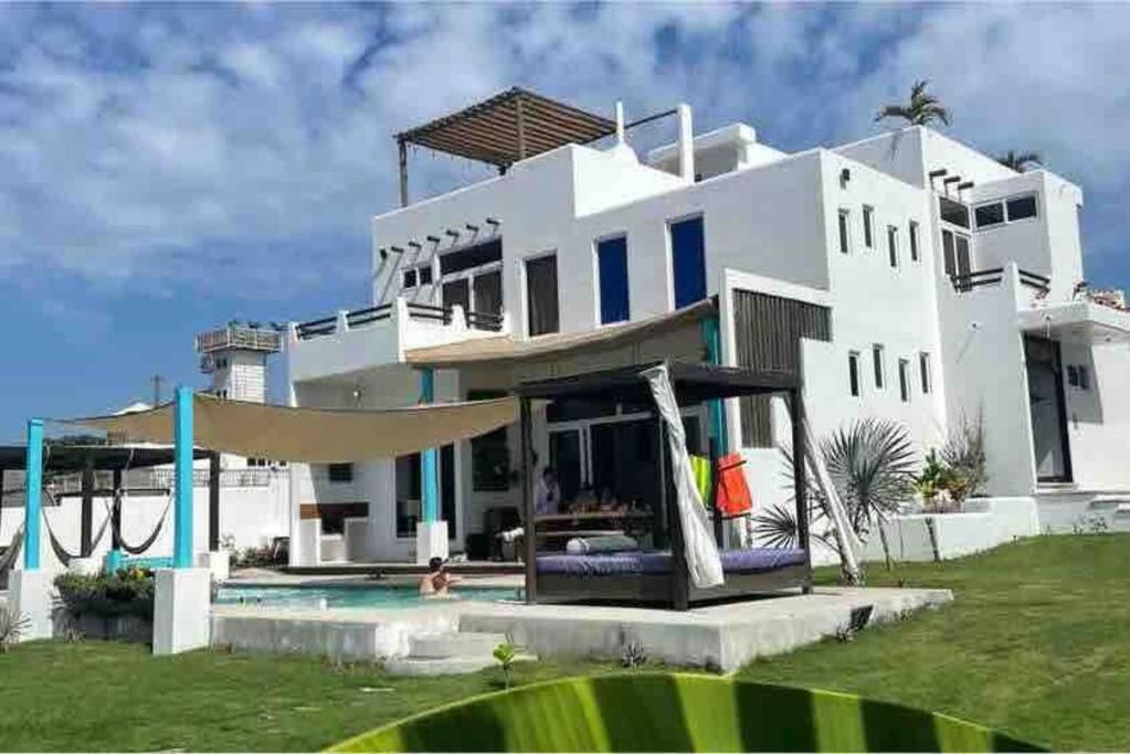 a large white house with a slide and a playground at Casa Apolonia in Guatemala