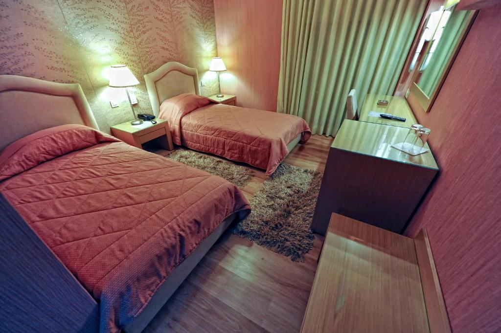 Postel nebo postele na pokoji v ubytování Haikos Hotel
