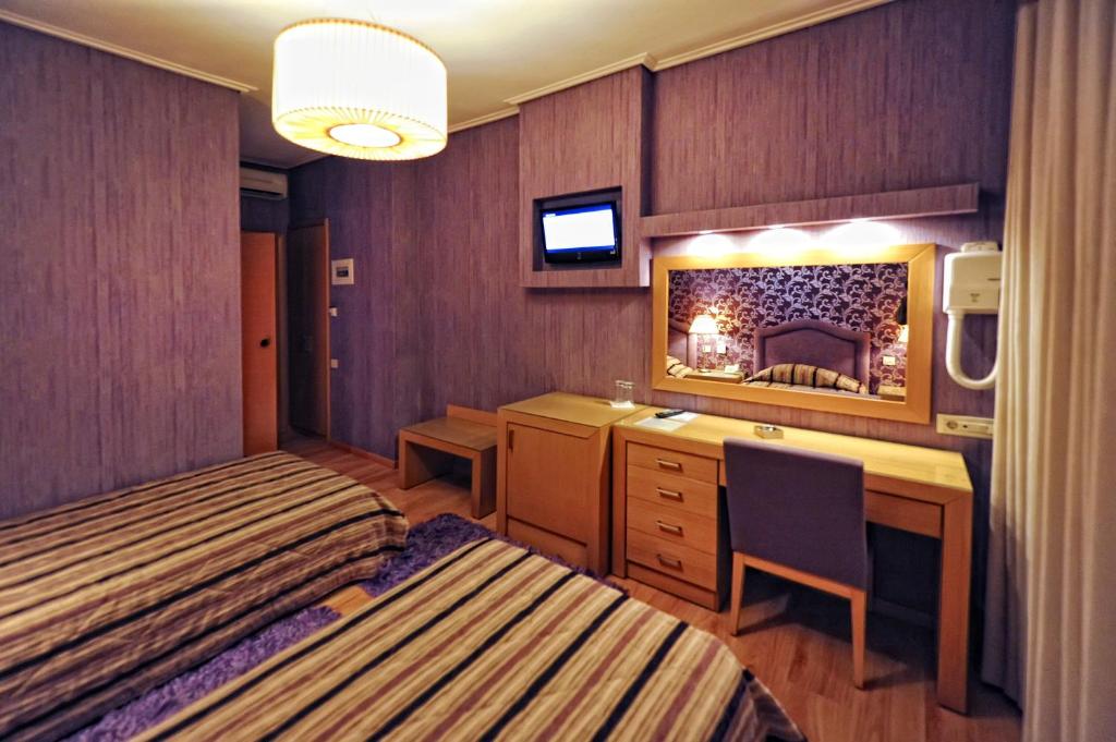 Postel nebo postele na pokoji v ubytování Haikos Hotel