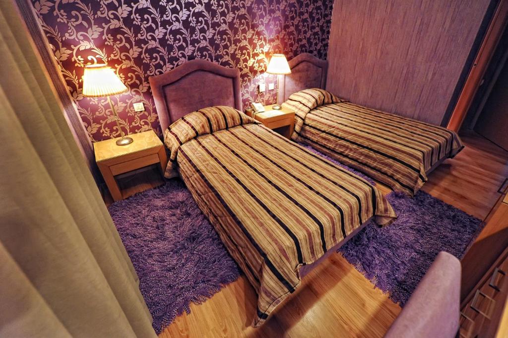 Postel nebo postele na pokoji v ubytování Haikos Hotel