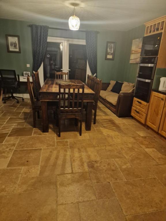 a living room with a table and chairs and a couch at Shanadune in Tralee
