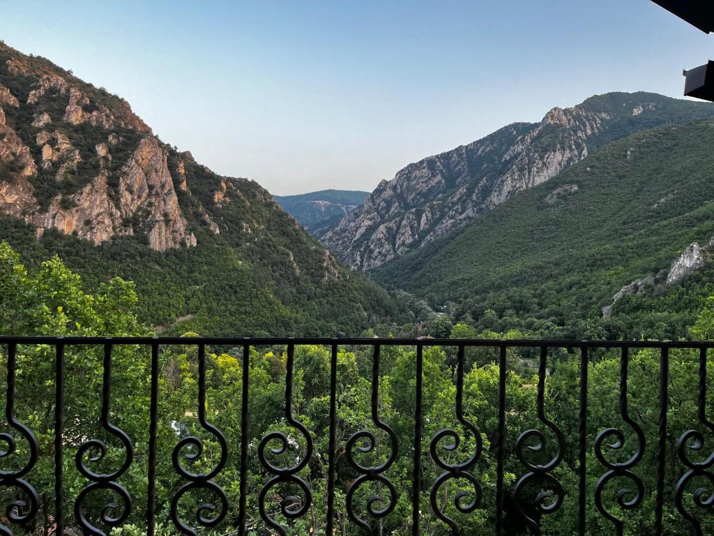 a view of the mountains from a balcony at Canyon View Lodge - Matka in Matka