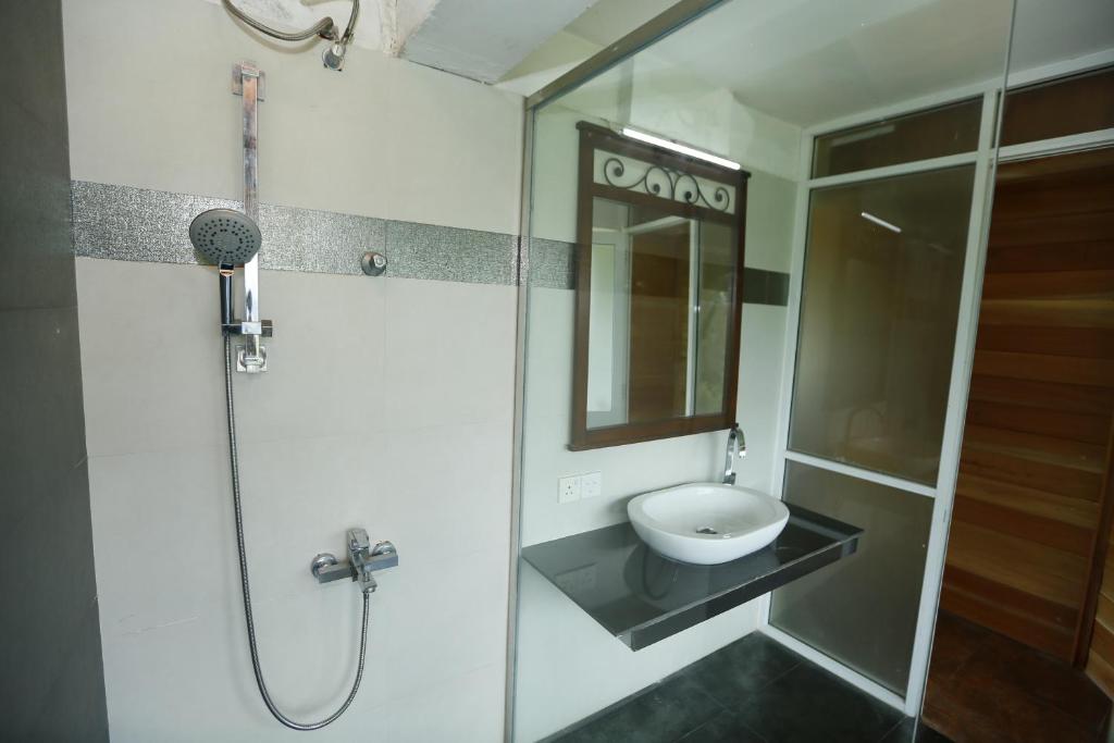 a bathroom with a sink and a shower at Crown hills kandy in Kandy