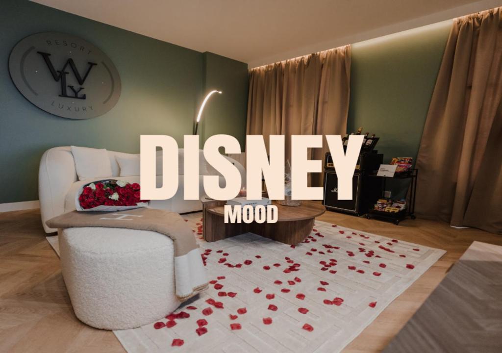 a living room with a sign for disney model at DISNEY MOOD BY WELOVEYOU® in Bailly-Romainvilliers