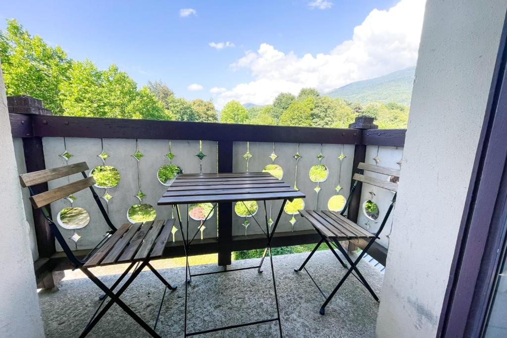 a table and chairs on a balcony with a view at The Golfer&#39;s Nest #FP in Vaulnaveys-le-Haut