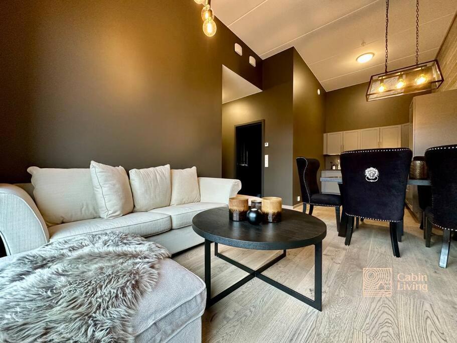 a living room with a couch and a table at New high standard apartment in Trysil with ski in out in Trysil