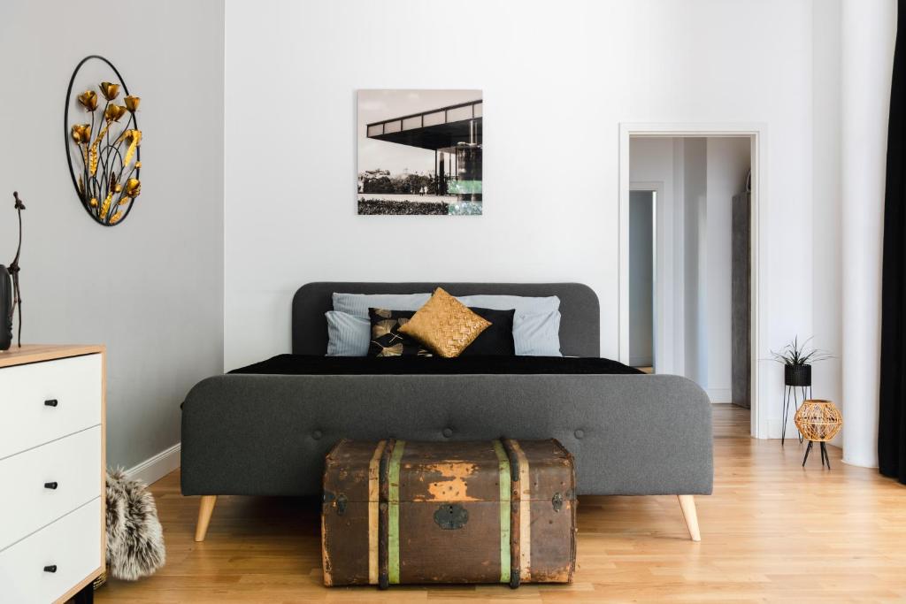 um quarto com uma cama com uma bagageira no chão em 90sqm 2BR Design Gem - outdoor terrace em Berlim