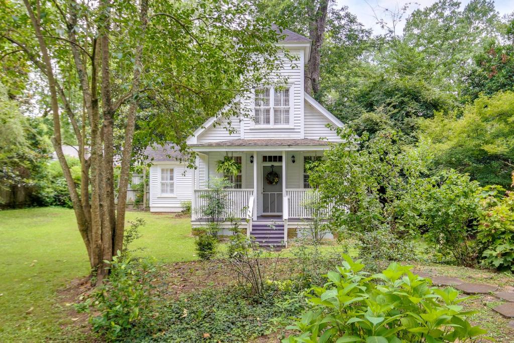 una casa bianca con portico e alberi di Romantic Cottage in Washington Historic District a Washington
