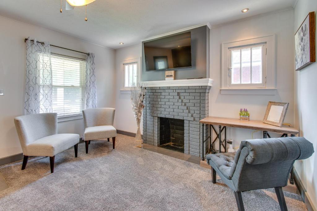 a living room with a fireplace and a tv at Charming Springfield Home 2 Mi to Downtown in Springfield
