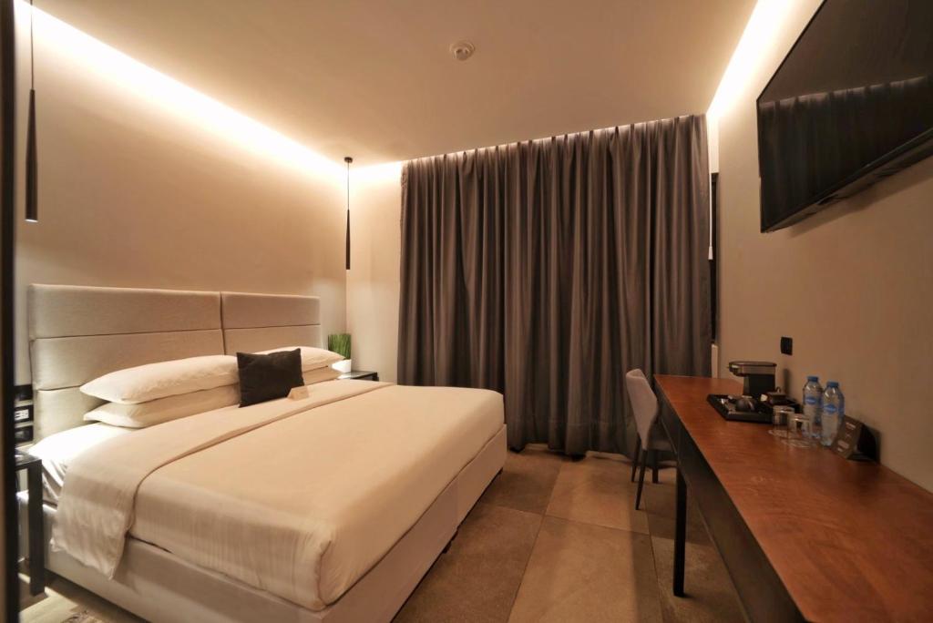 Postel nebo postele na pokoji v ubytování Ontico Urban Design Hotel