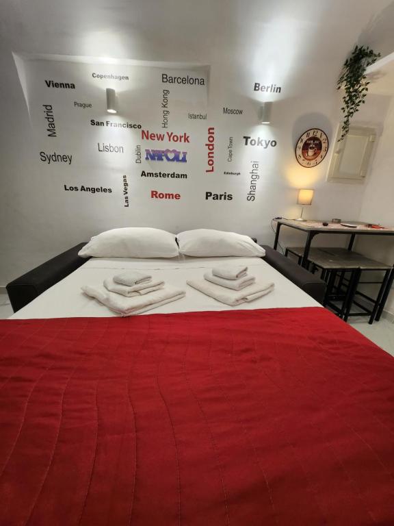 a bedroom with a bed with a red blanket at Suite SANTA CHIARA in Naples