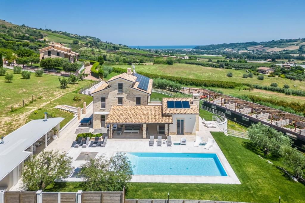an aerial view of a house with a swimming pool at Villa Amore di Ada - Design, AirCo, Private Pool & Near The Beach in Monterubbiano