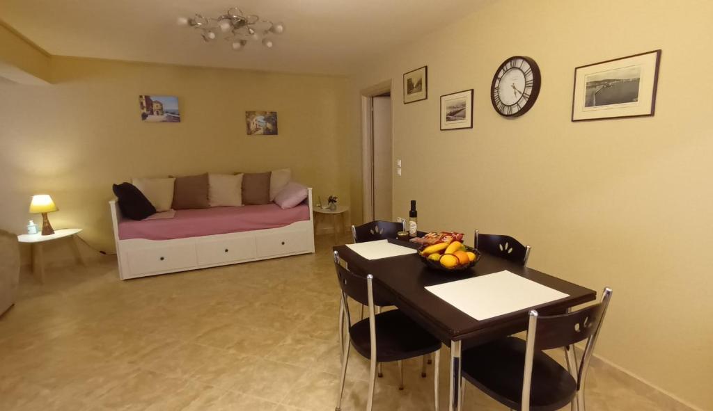a living room with a table and a couch at LIVIERATOS APARTMENTS in Lixouri