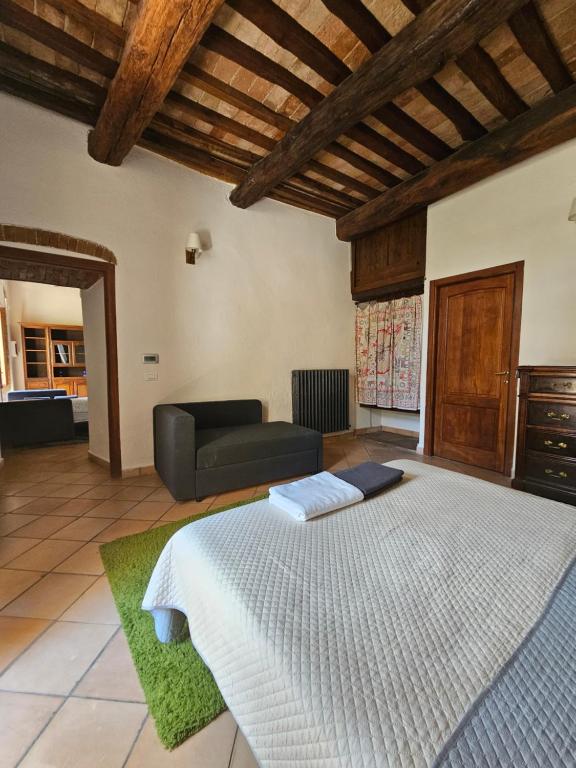 a large bedroom with a bed and a couch at "Castel D Arno Guest House Assisi Perugia" in Pianello